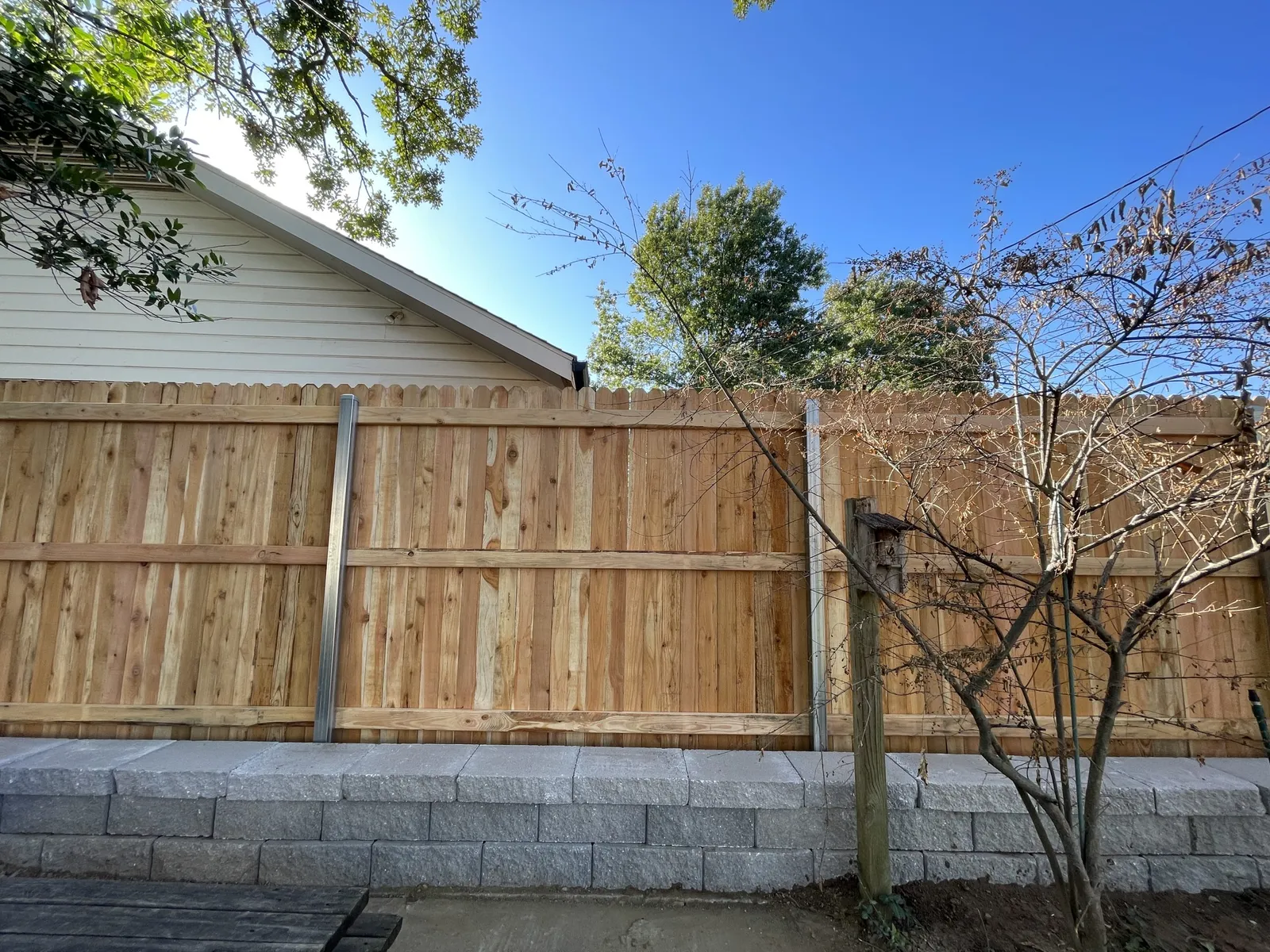 Clean cedar wood fence in a Tulsa backyard after washing