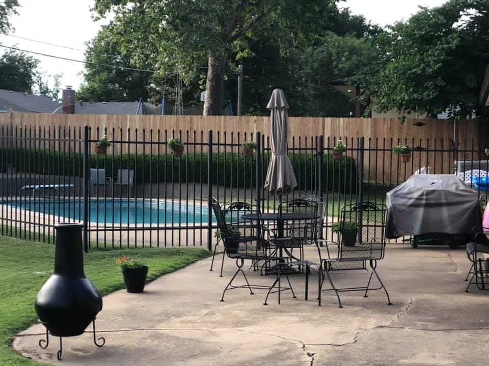 Black ornamental iron pool safety fence, a wrought iron fence Tulsa, OK pool enclosure