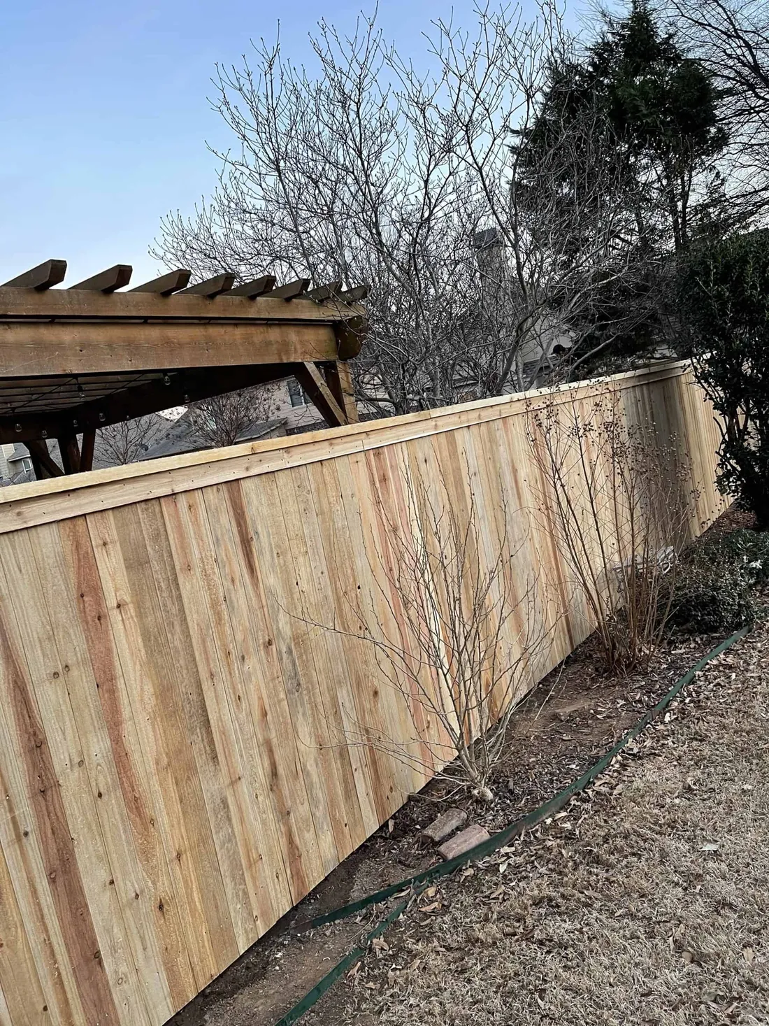 Cedar double gate with decorative hinges, a custom gate built in Tulsa, OK