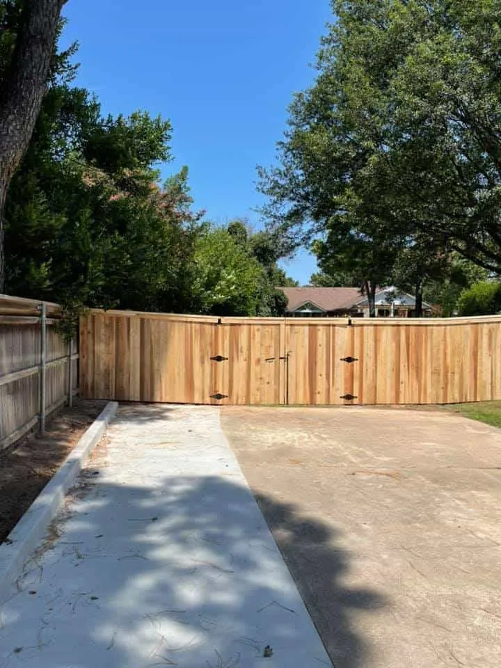 Cedar double driveway gate over a concrete drive, part of a privacy fence Tulsa, OK project