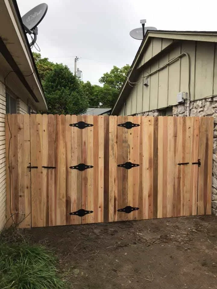 Cedar dog-ear double gate across a side yard, part of a privacy fence Tulsa, OK project