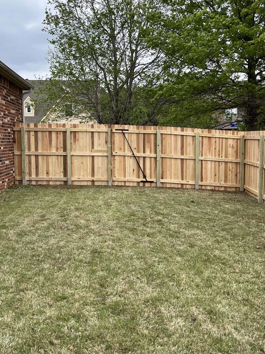 Cedar privacy fence and gate with a green lawn, a privacy fence Tulsa, OK build
