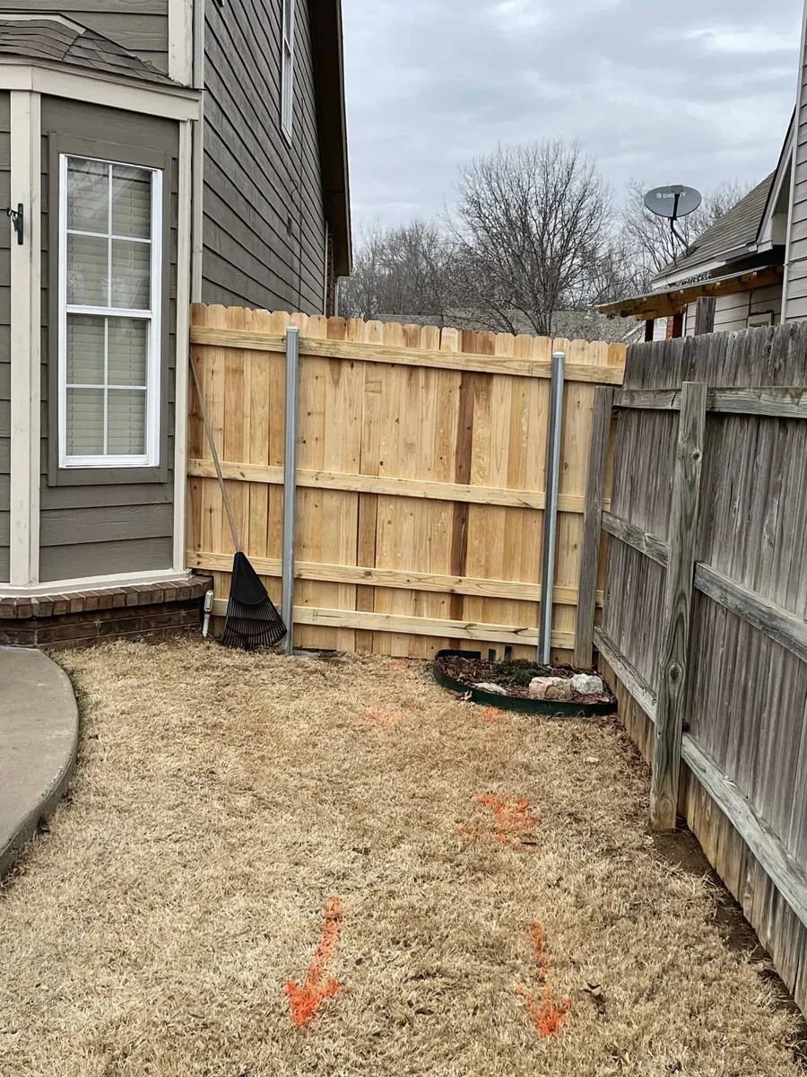 Cedar privacy fence with a braced gate in a yard, a privacy fence Tulsa, OK build