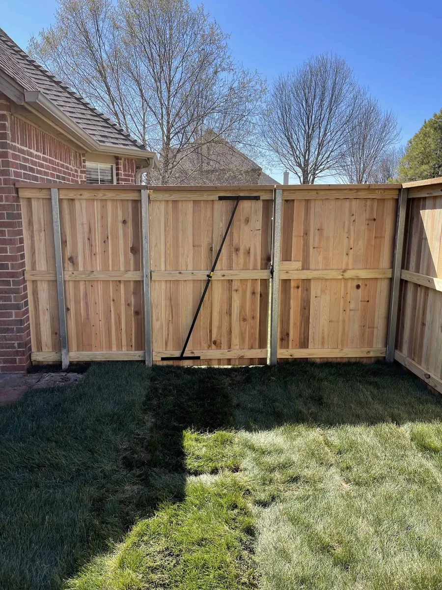 Cedar privacy gate with a diagonal brace in a backyard, a custom gate in Tulsa, OK