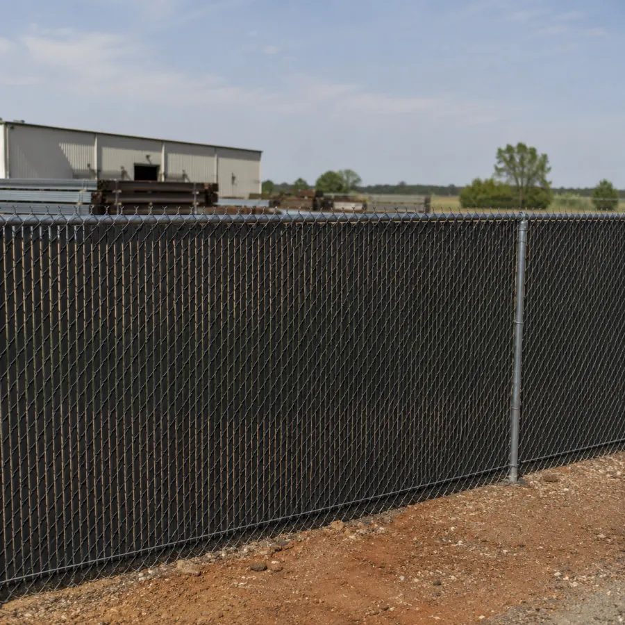 Commercial chain link fence with security slats around a Tulsa, OK property