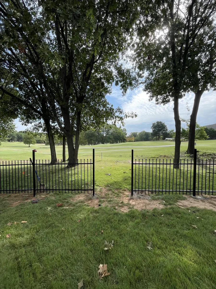 Black ornamental iron fence overlooking parkland, an ornamental fence in Tulsa, OK