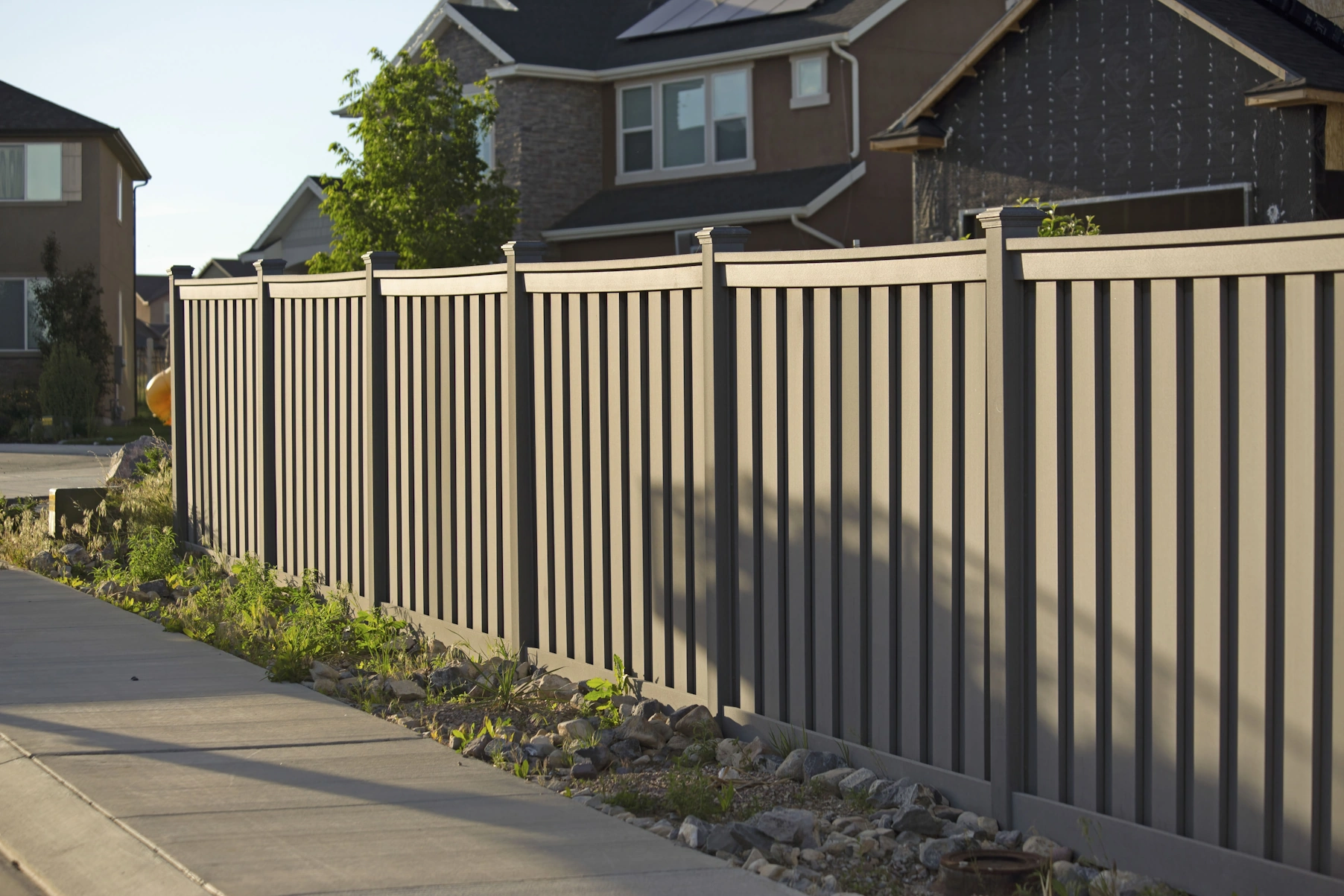 Tan vinyl privacy fence along a residential yard in Tulsa, OK