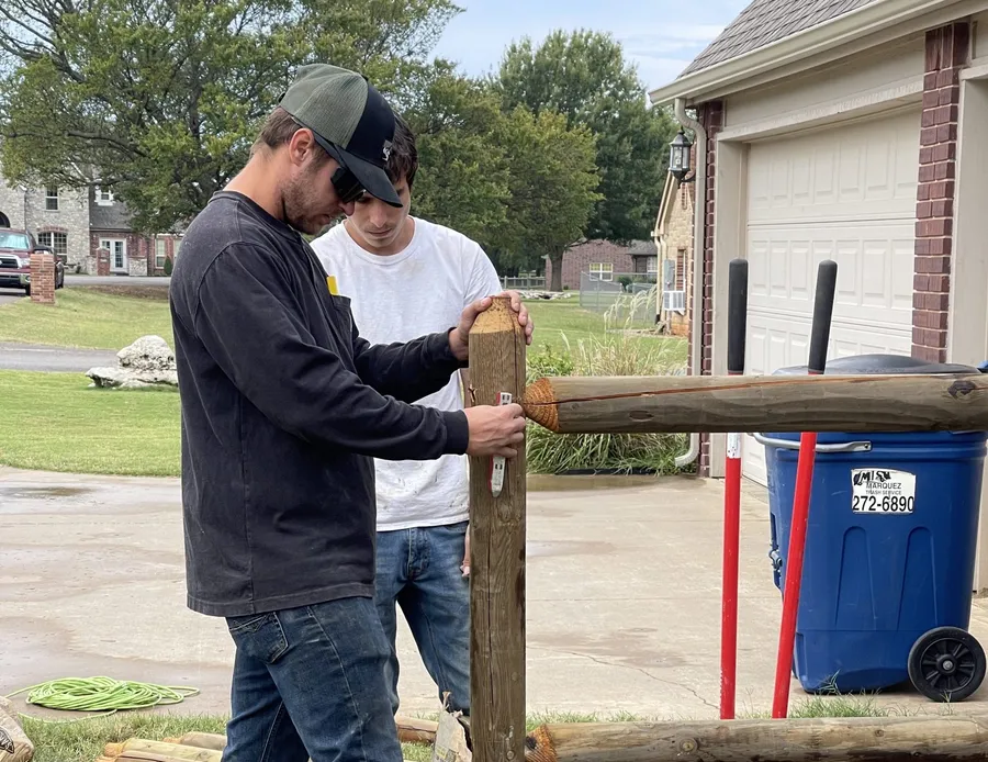 Crew completing a cedar privacy fence, wood fence installation near me Tulsa, OK