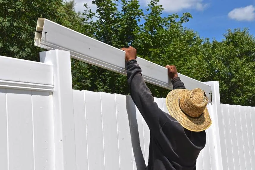 Completing a white vinyl privacy fence, white vinyl fence installation near me Broken Arrow, OK