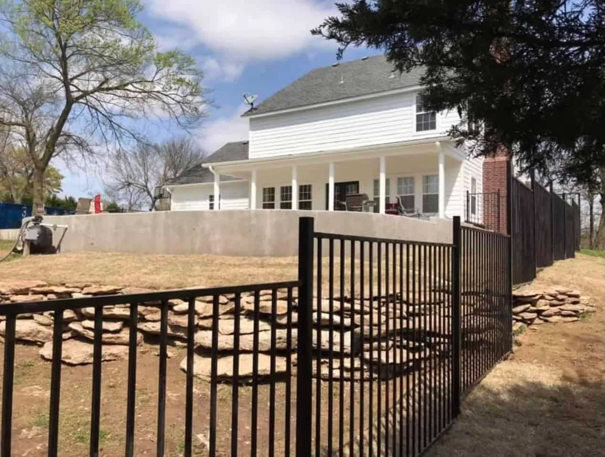 Black ornamental fence and gate, a wrought iron fence Tulsa, OK homeowners admire
